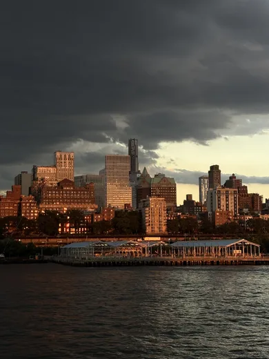 A city skyline at dusk across the water