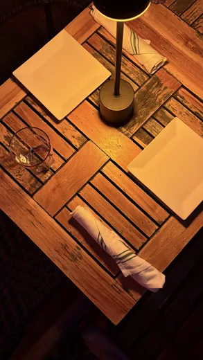 A candle lamp on a warm wooden table
