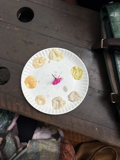 A paper plate with small desserts