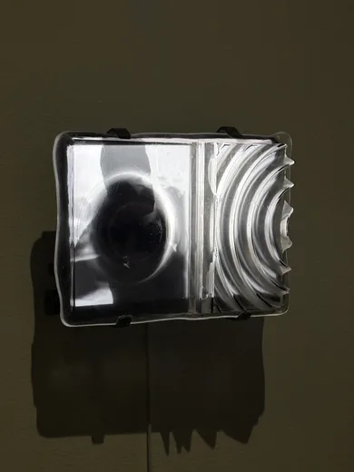 A video monitor on a dark gallery wall